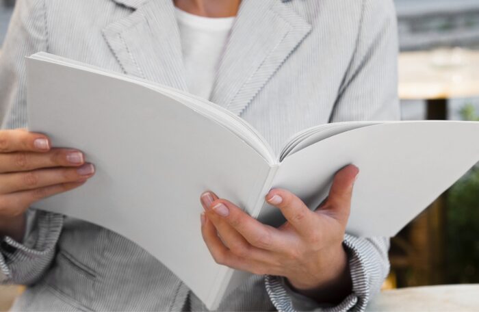 person holding booklet